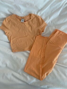 Aritzia TNA Matching light orange cropped top and leggings